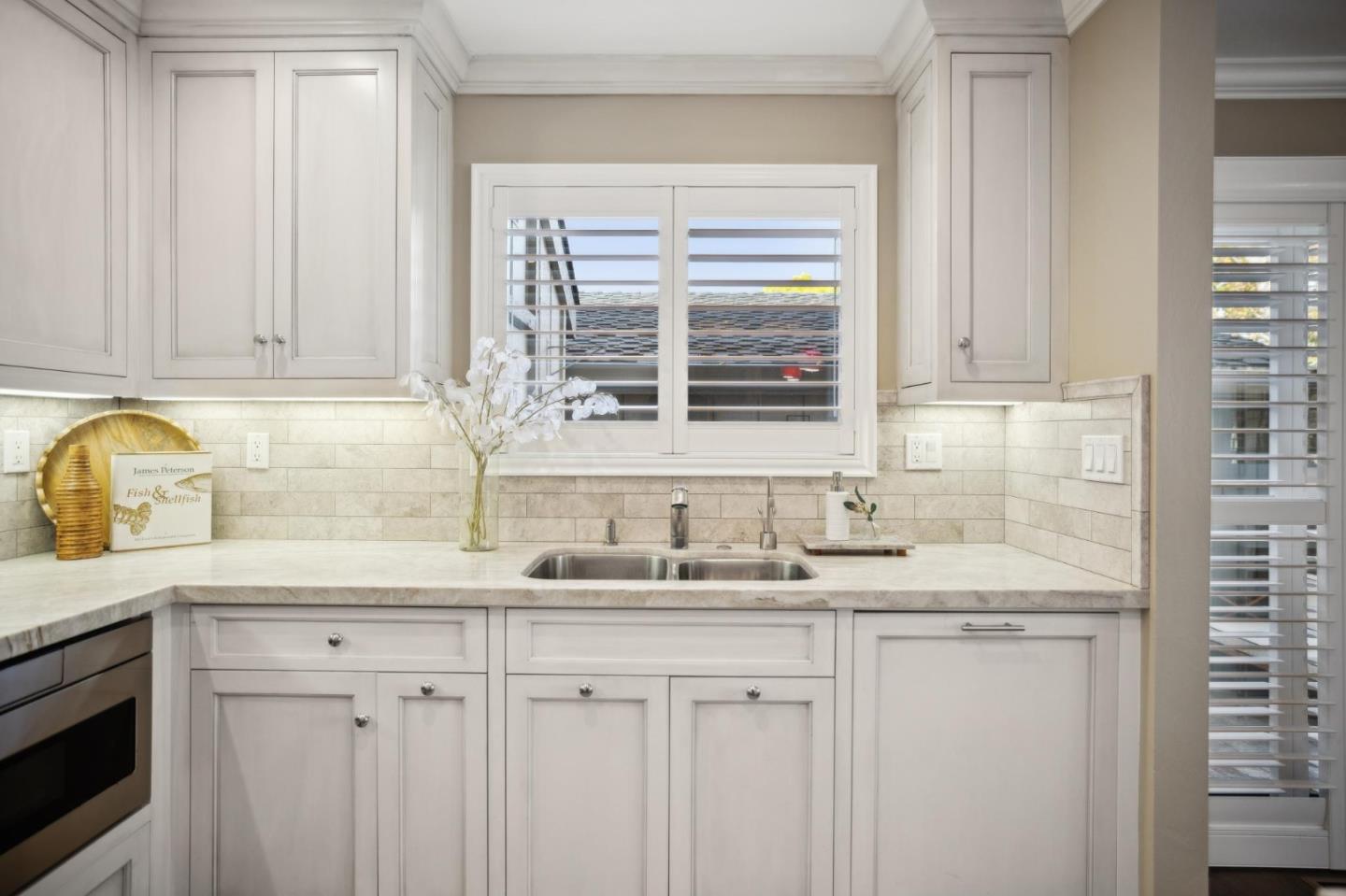 3850 Rio Road, Unit 1 Carmel, CA 93923 - Photo 17 of 46 a kitchen with stainless steel appliances granite countertop white cabinets and a sink