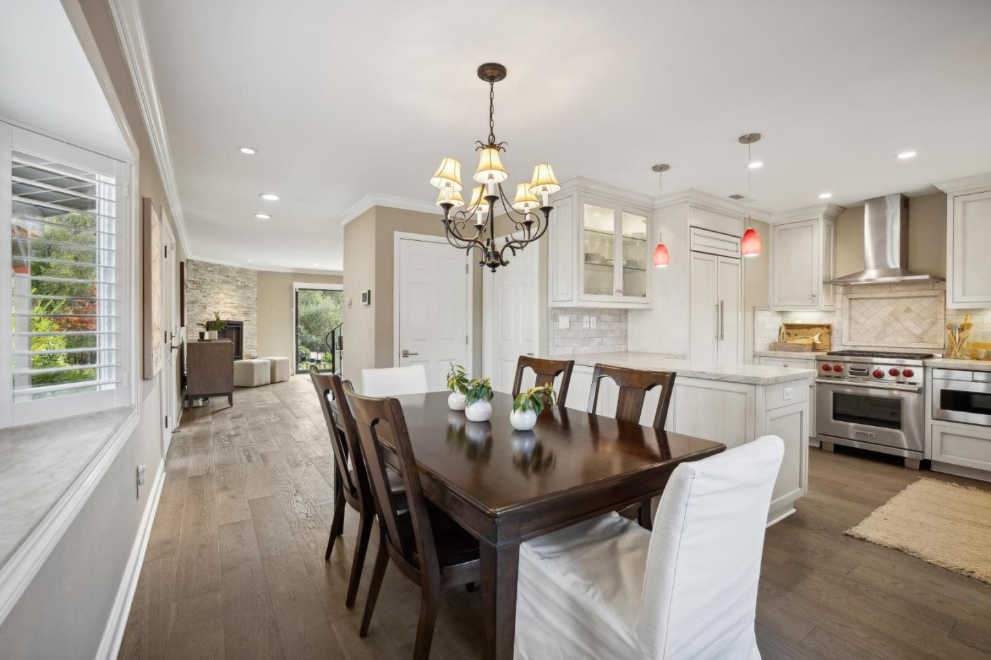3850 Rio Road, Unit 1 Carmel, CA 93923 - Photo 19 of 46 a view of a dining room with furniture and a chandelier