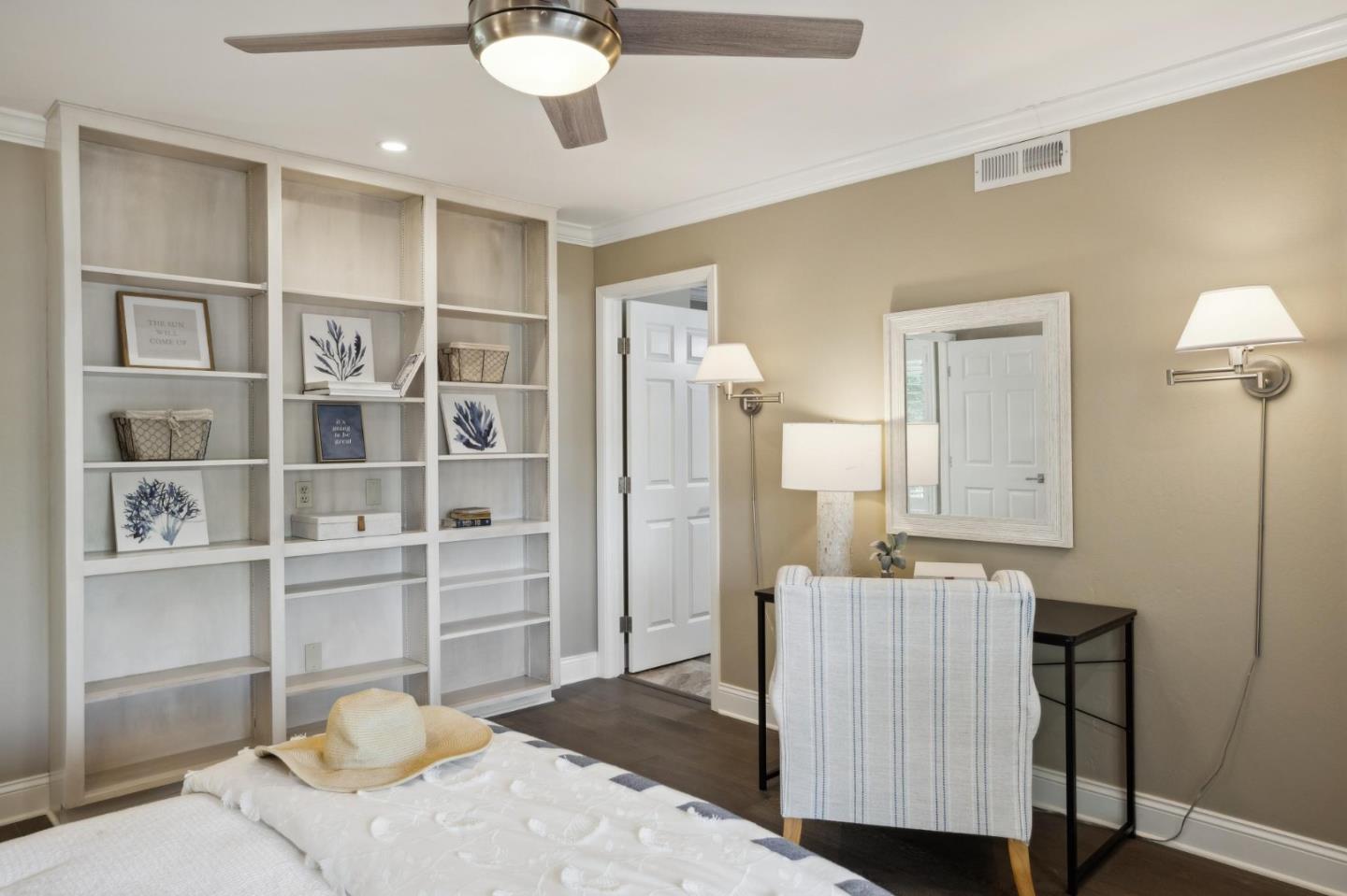 3850 Rio Road, Unit 1 Carmel, CA 93923 - Photo 34 of 46 a bedroom with a bed and a chandelier