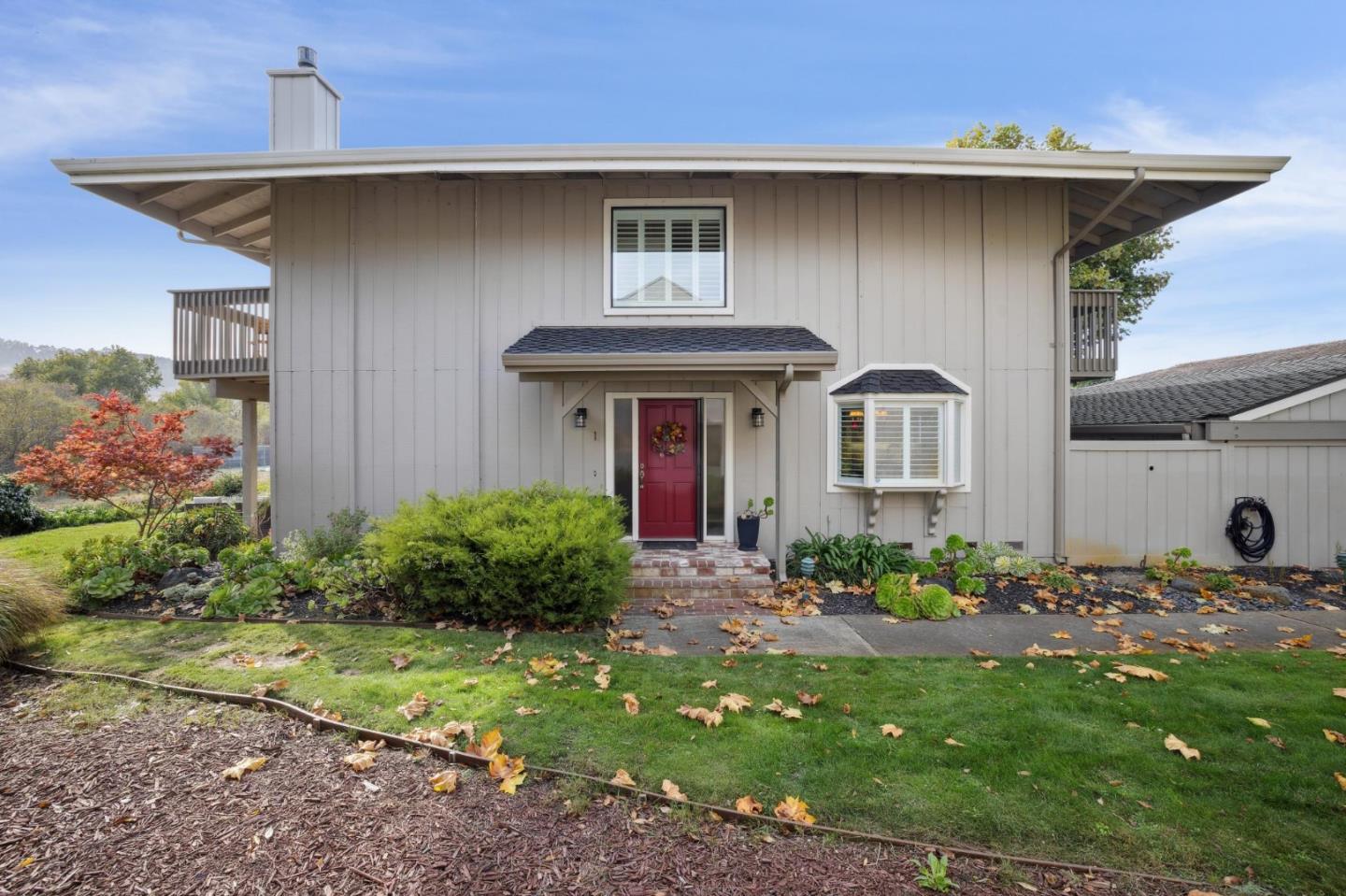 3850 Rio Road, Unit 1 Carmel, CA 93923 - Photo 4 of 46 a front view of a house with garden