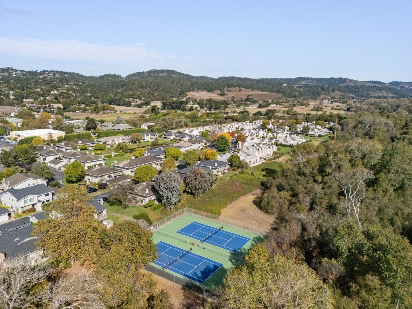 3850 Rio Road, Unit 1 Carmel, CA 93923 - Photo 46 of 46 an aerial view of residential houses with outdoor space and trees