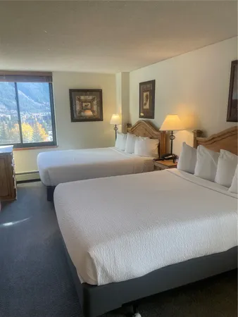 a bedroom with furniture and large windows