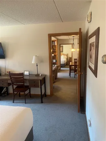a bedroom with a bed and lamp