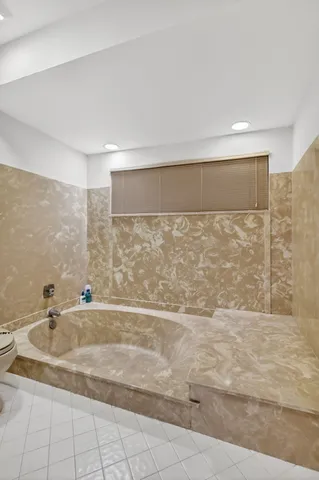 a bedroom with a bed and a television