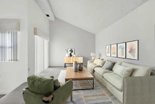 a living room with furniture and stairs