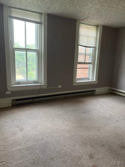 900 Mahantongo Street, Unit 5 Pottsville, PA 17901 - Photo 4 of 8 an empty room with wooden floor and windows