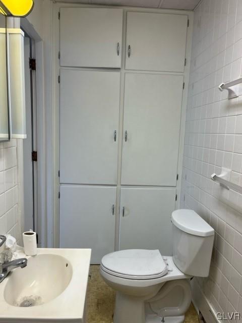 900 Mahantongo Street, Unit 5 Pottsville, PA 17901 - Photo 7 of 8 a white toilet sitting next to a bathroom sink