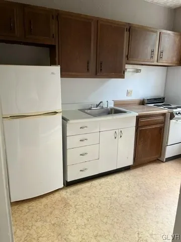 a kitchen with cabinets appliances