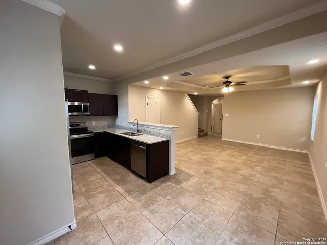 a kitchen with kitchen island a sink a counter top space and cabinets