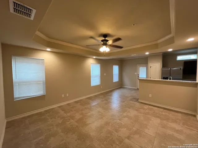 a view of an empty room with a ceiling fan