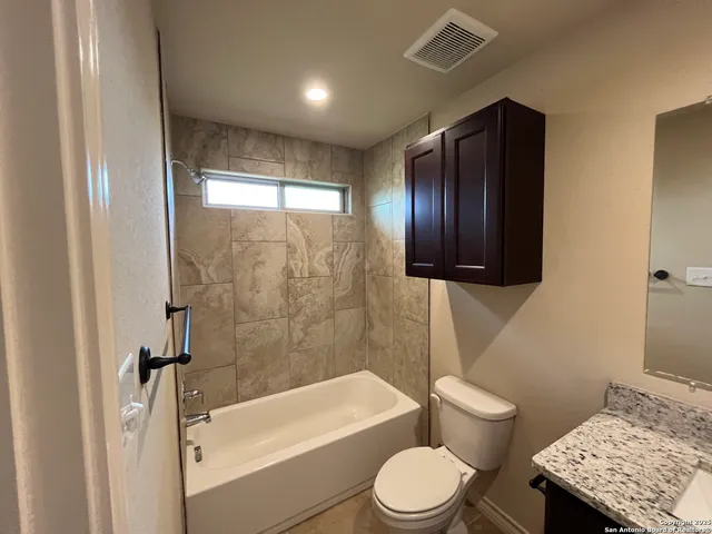 a bathroom with a toilet a sink and bathtub