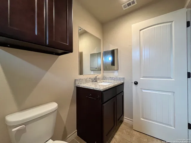a bathroom with a sink a toilet and mirror