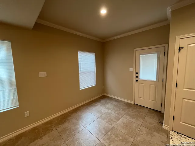 an empty room with windows and closet