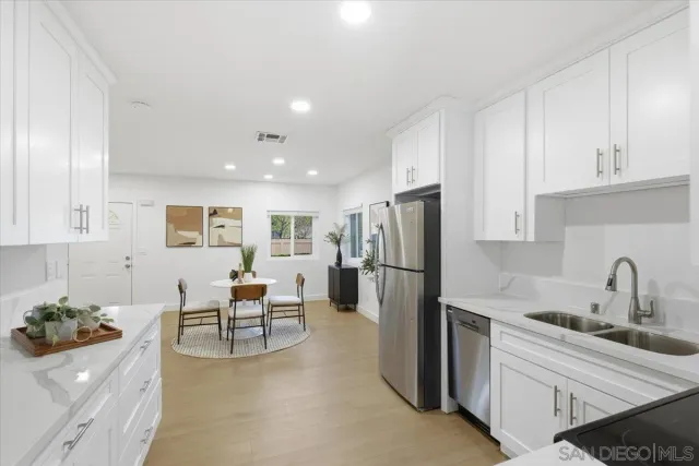 a kitchen with a refrigerator and a sink