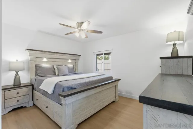 a bed room with a bed and a ceiling fan