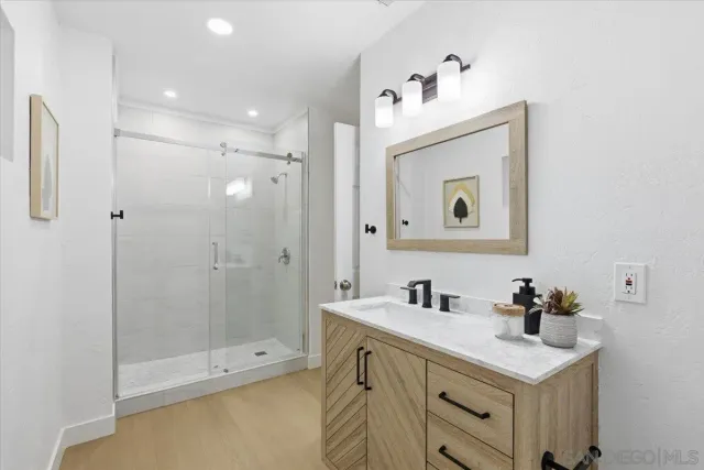 a bathroom with a sink vanity and a mirror