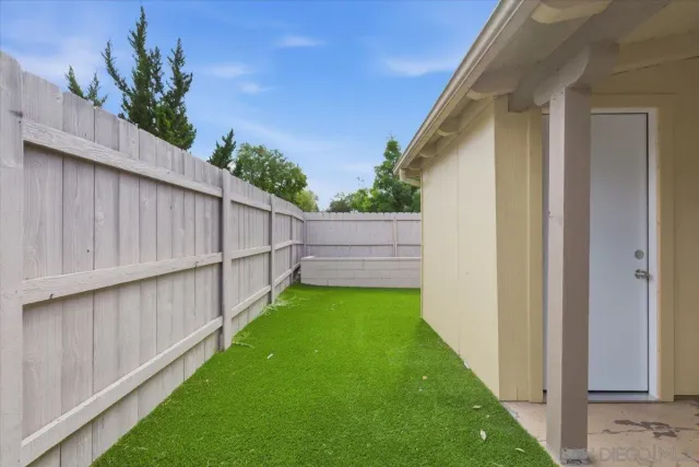 a view of small yard with wooden fence