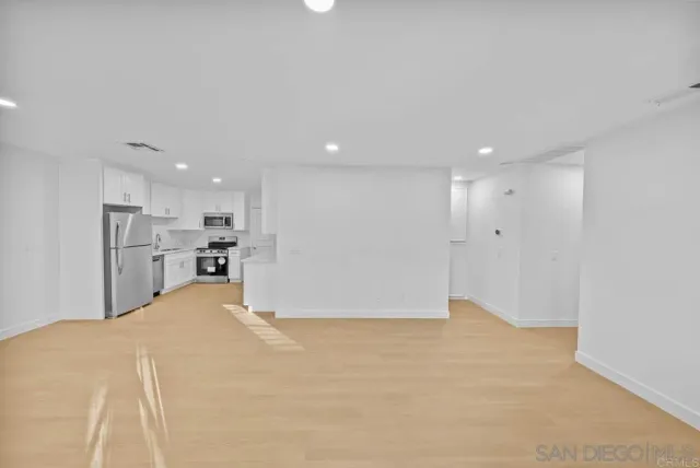 a view of kitchen and refrigerator