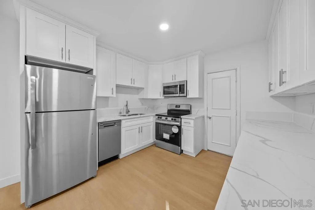 911 Jamacha Road El Cajon, CA 92019 - Photo 31 of 34 a kitchen with cabinets stainless steel appliances and a refrigerator