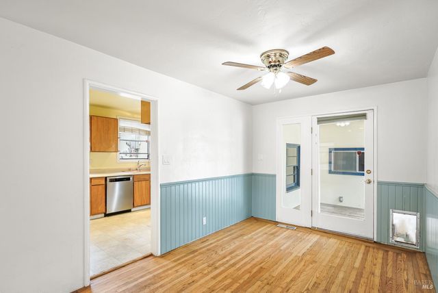a view of a kitchen with a sink and a refrigerator