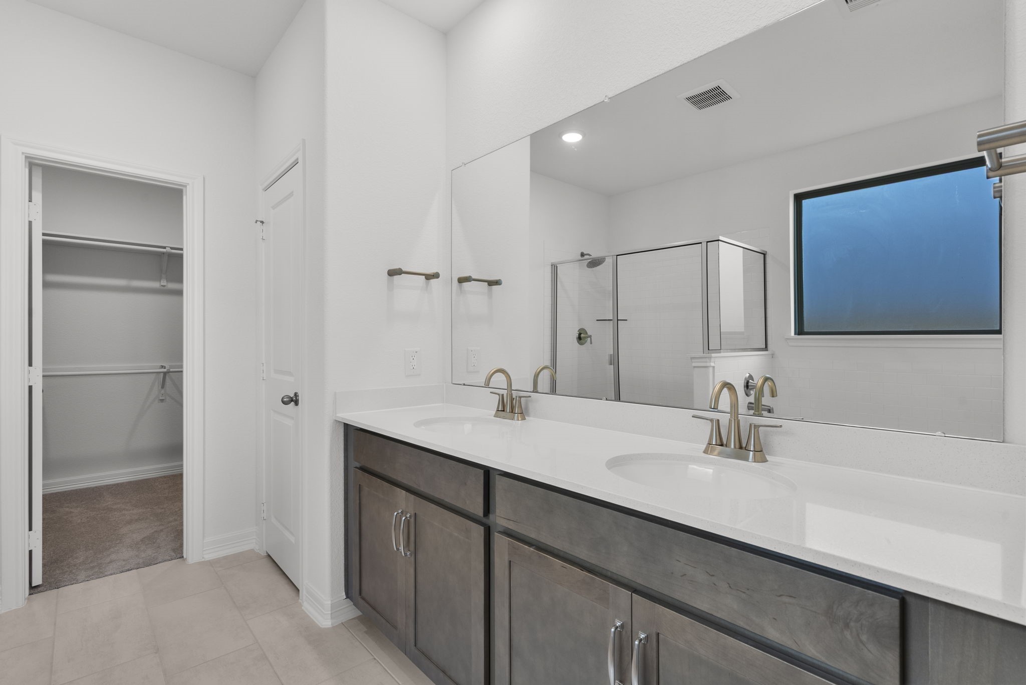 24218 Dewey Trail Magnolia, TX 77355 - Photo 13 of 38 a bathroom with a double vanity sink a mirror and a shower