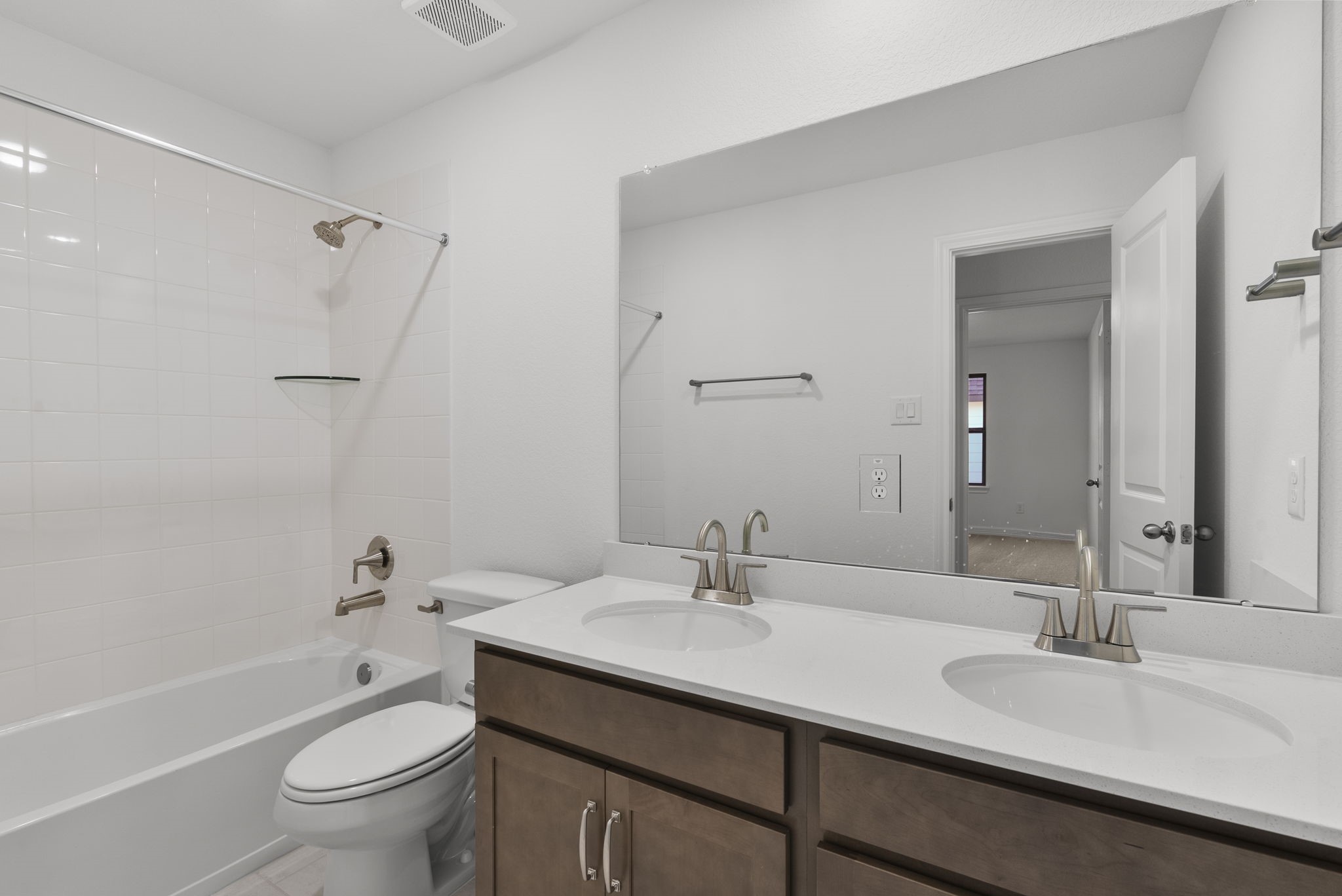 24218 Dewey Trail Magnolia, TX 77355 - Photo 25 of 38 a bathroom with a granite countertop sink a toilet and a large mirror