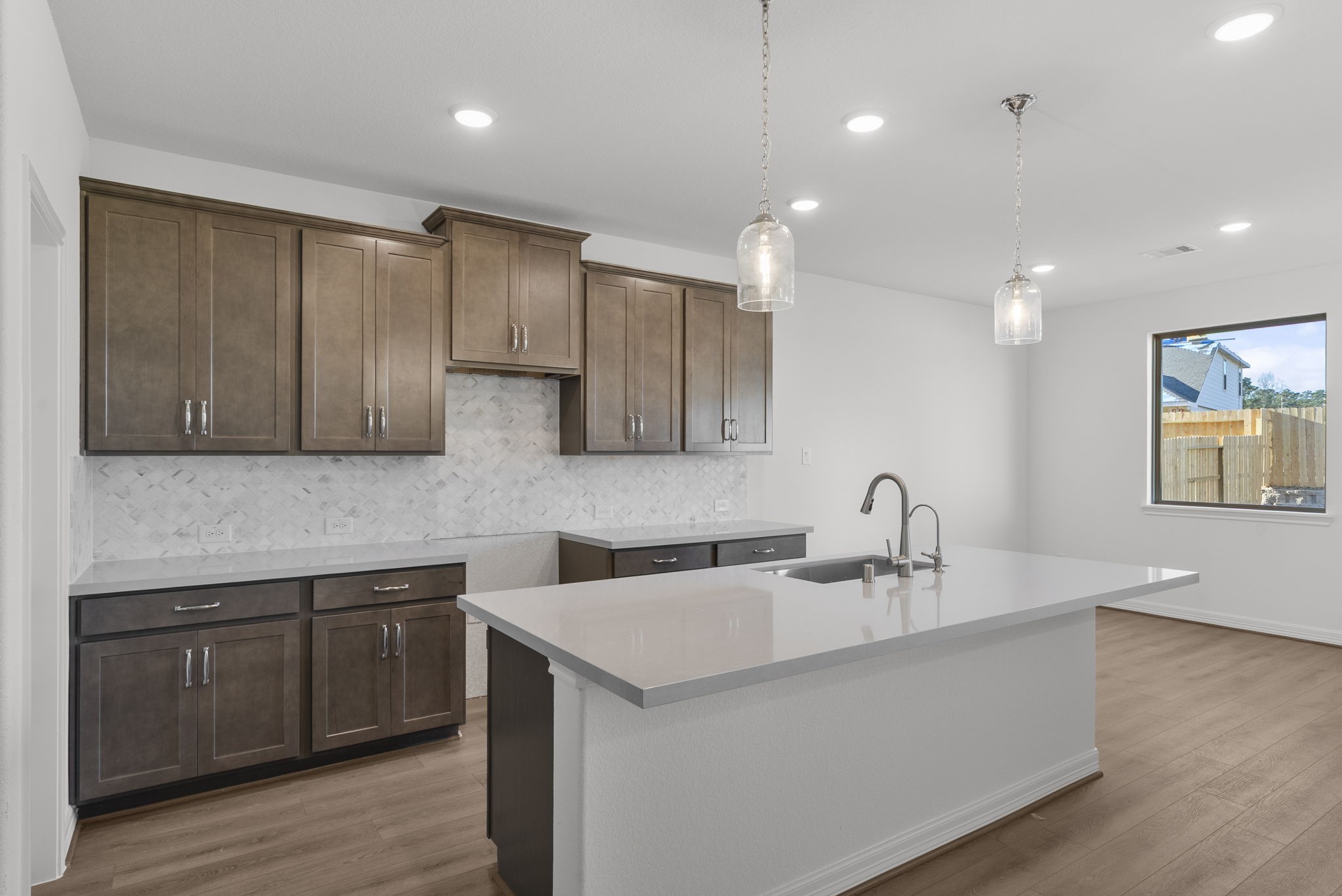 24218 Dewey Trail Magnolia, TX 77355 - Photo 5 of 38 a kitchen with a sink cabinets and wooden floor