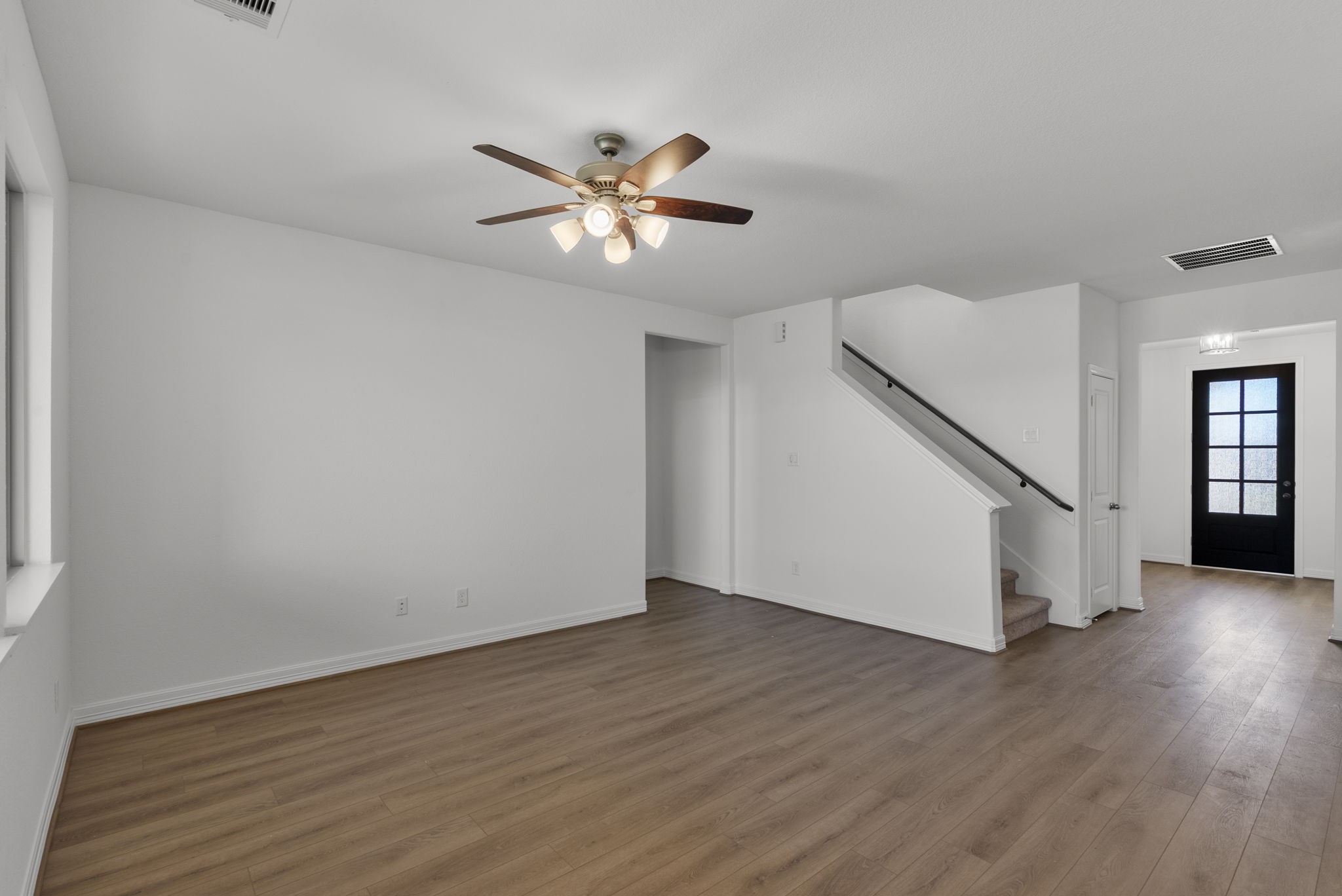 24218 Dewey Trail Magnolia, TX 77355 - Photo 7 of 38 a view of empty room with wooden floor and fan
