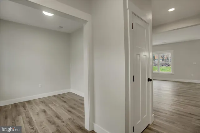 a view of a hallway with wooden floor