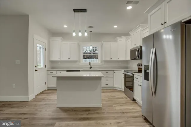 a kitchen with a refrigerator and a sink
