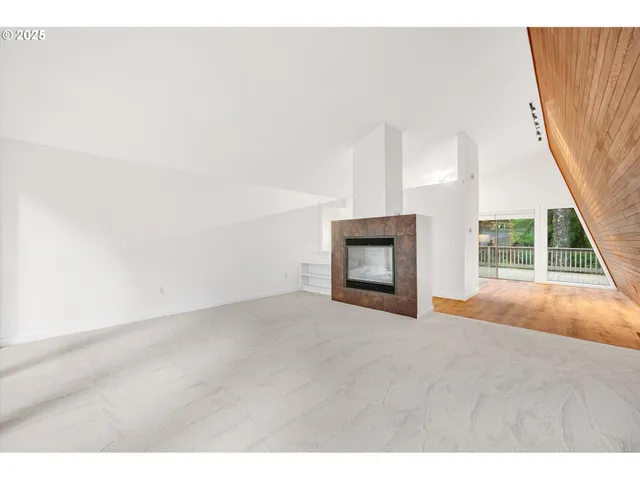 a view of empty room with a fireplace