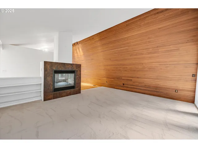 a view of an empty room and fire place