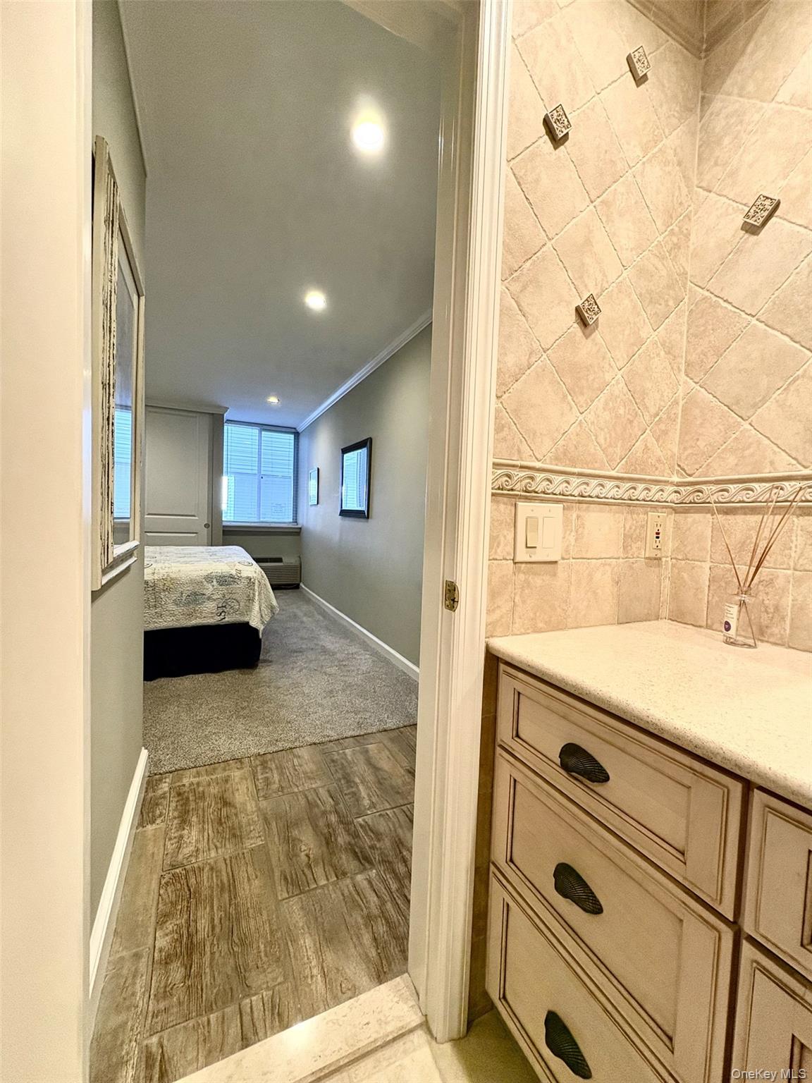 253 Dune Road, Unit 49 Westhampton Beach, NY 11978 - Photo 11 of 31 a bedroom with a bed and a window