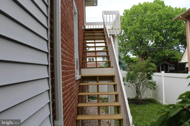 a view of a tall building next to a yard