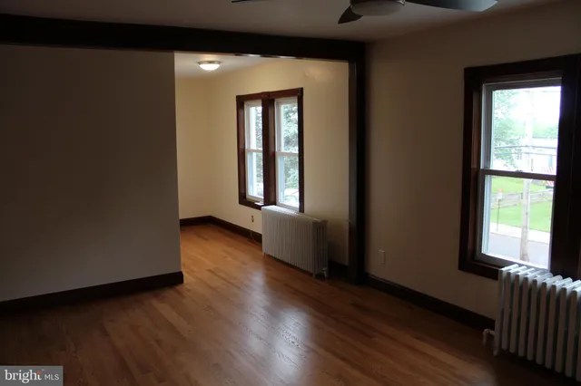 a view of a room with wooden floor and window