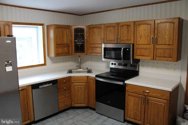 a kitchen with a sink stove and microwave