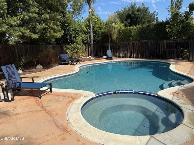 a view of a swimming pool with a patio