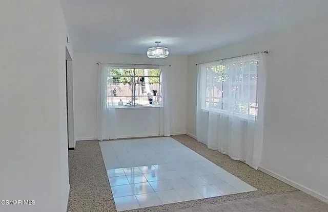 a kitchen with stainless steel appliances white cabinets and a window