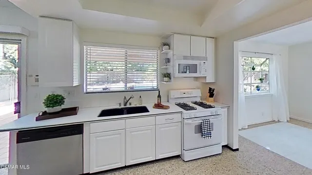 a kitchen with a sink stove and refrigerator
