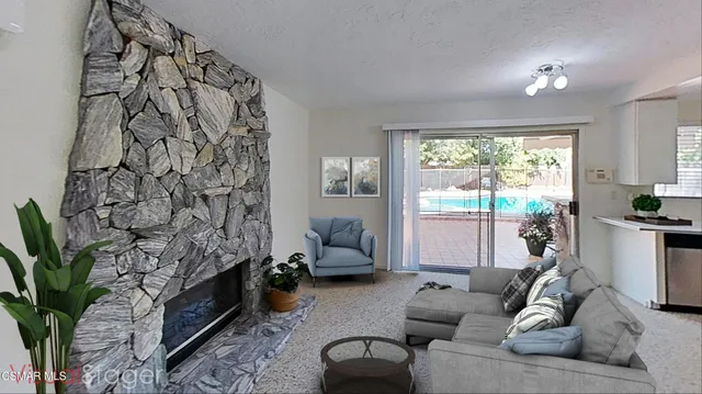 a room with a fireplace and a potted plant