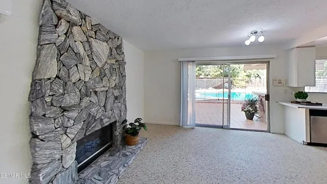 a view of a patio with table and chairs and potted plants