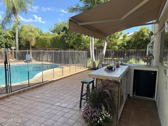 a view of a backyard with sitting area
