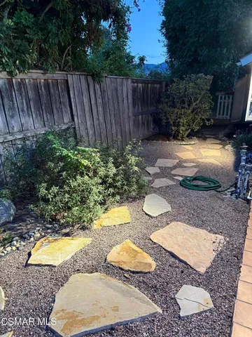 a view of a patio with table and chairs