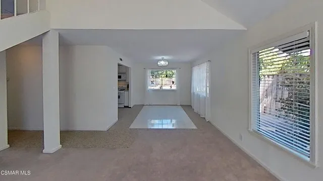 a view of a kitchen with a sink stove and stairs