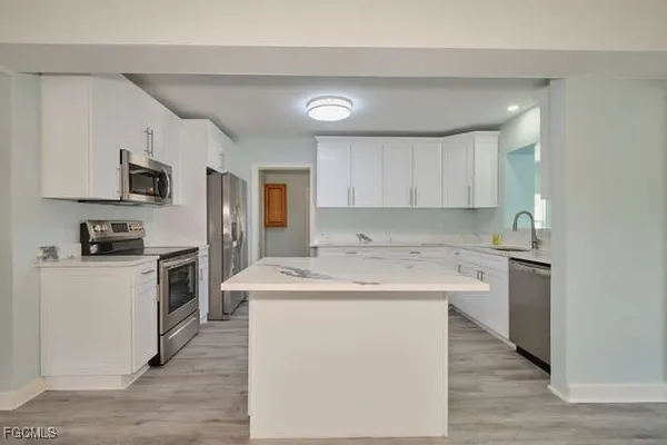 a kitchen with a sink stove and refrigerator