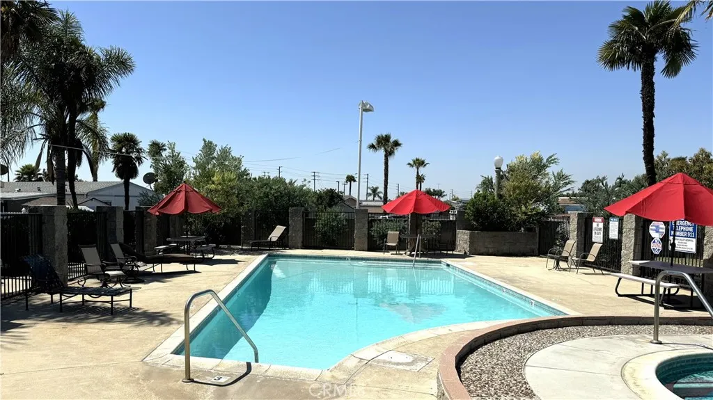 3745 Valley Walnut Ca, Unit 84 Walnut, CA 91789 - Photo 18 of 18 a view of a swimming pool with a patio and a yard