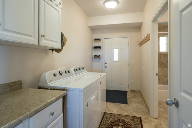 684 Blue Mountain Ridge Monticello, UT 84535 - Photo 41 of 71 Laundry area featuring washer and clothes dryer, cabinet space, and light tile patterned floors