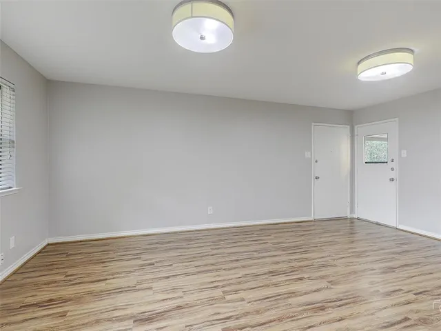a view of room with wooden floor and window
