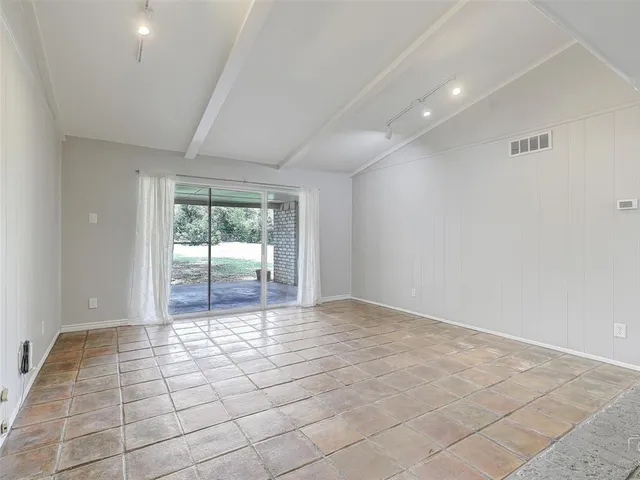 a view of an empty room with glass door