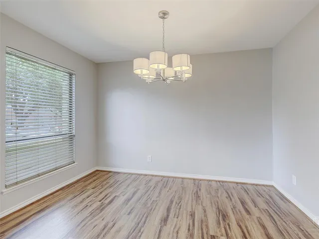 a view of a room with wooden floor and windows